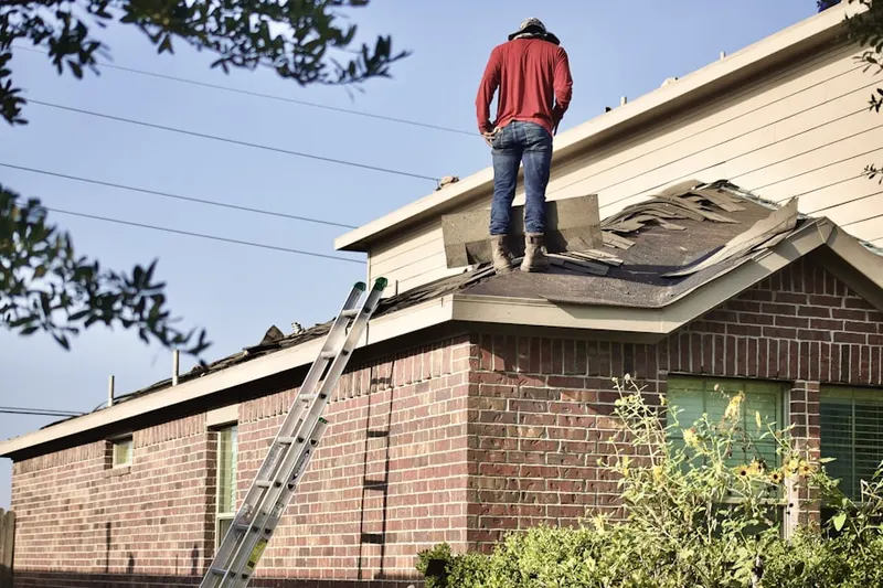Professional roofer working on a residential roof in Westfield Village